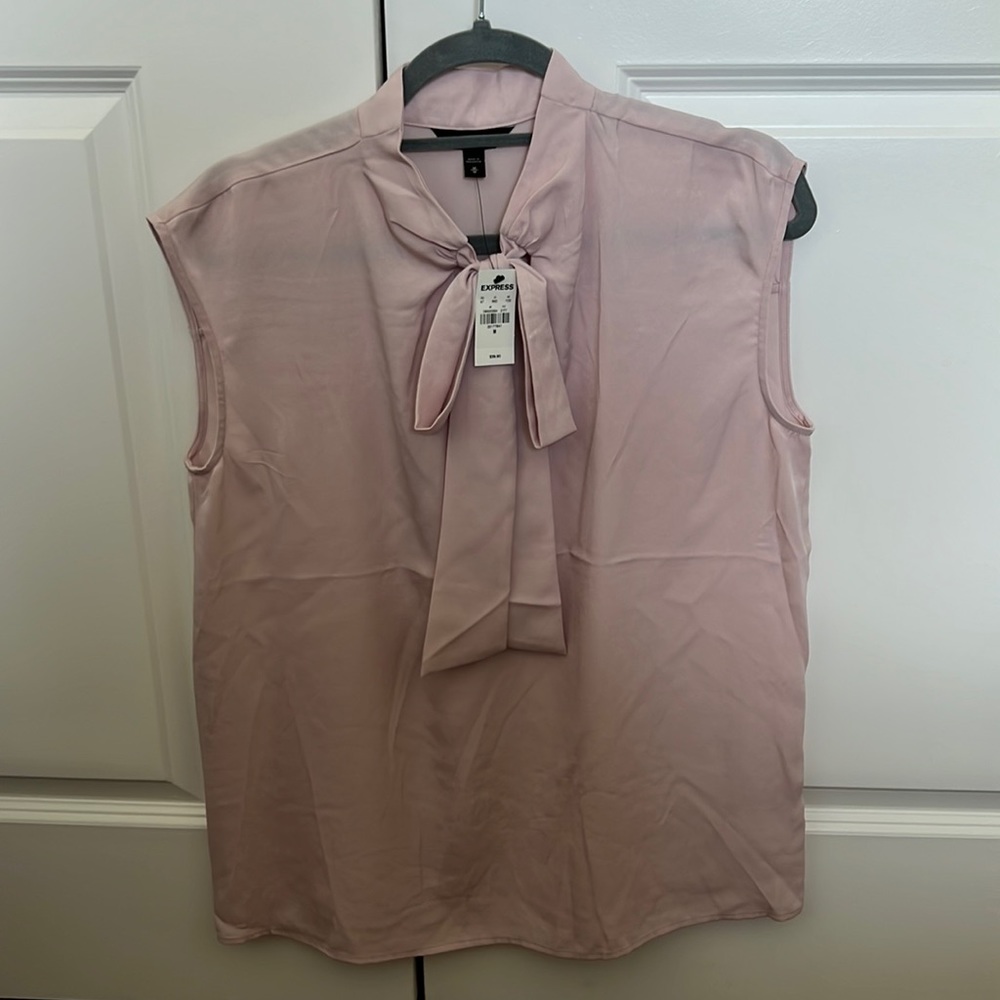 Express light pink sleeveless blouse size medium with front tie.